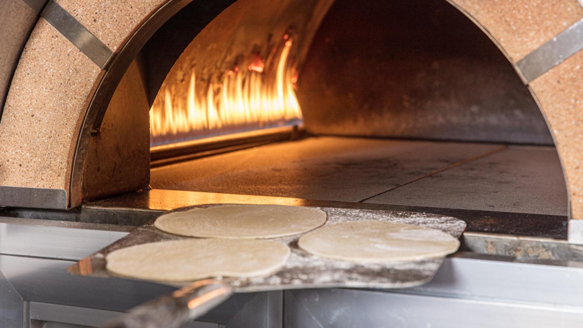 The Abdali Boulevard Hotel Αμμάν Εξωτερικό φωτογραφία Pizza dough in a wood-fired oven